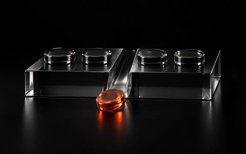 Four glass counters sit on a plinth while one escaped token glows orange