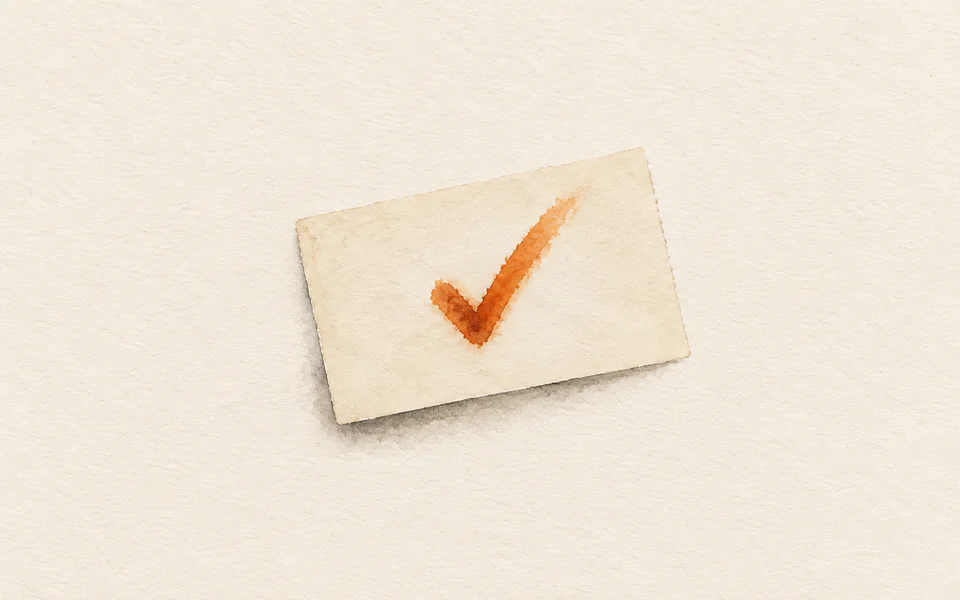 Watercolour of a blank index card lying alone, one orange tick mark bleeding into its surface
